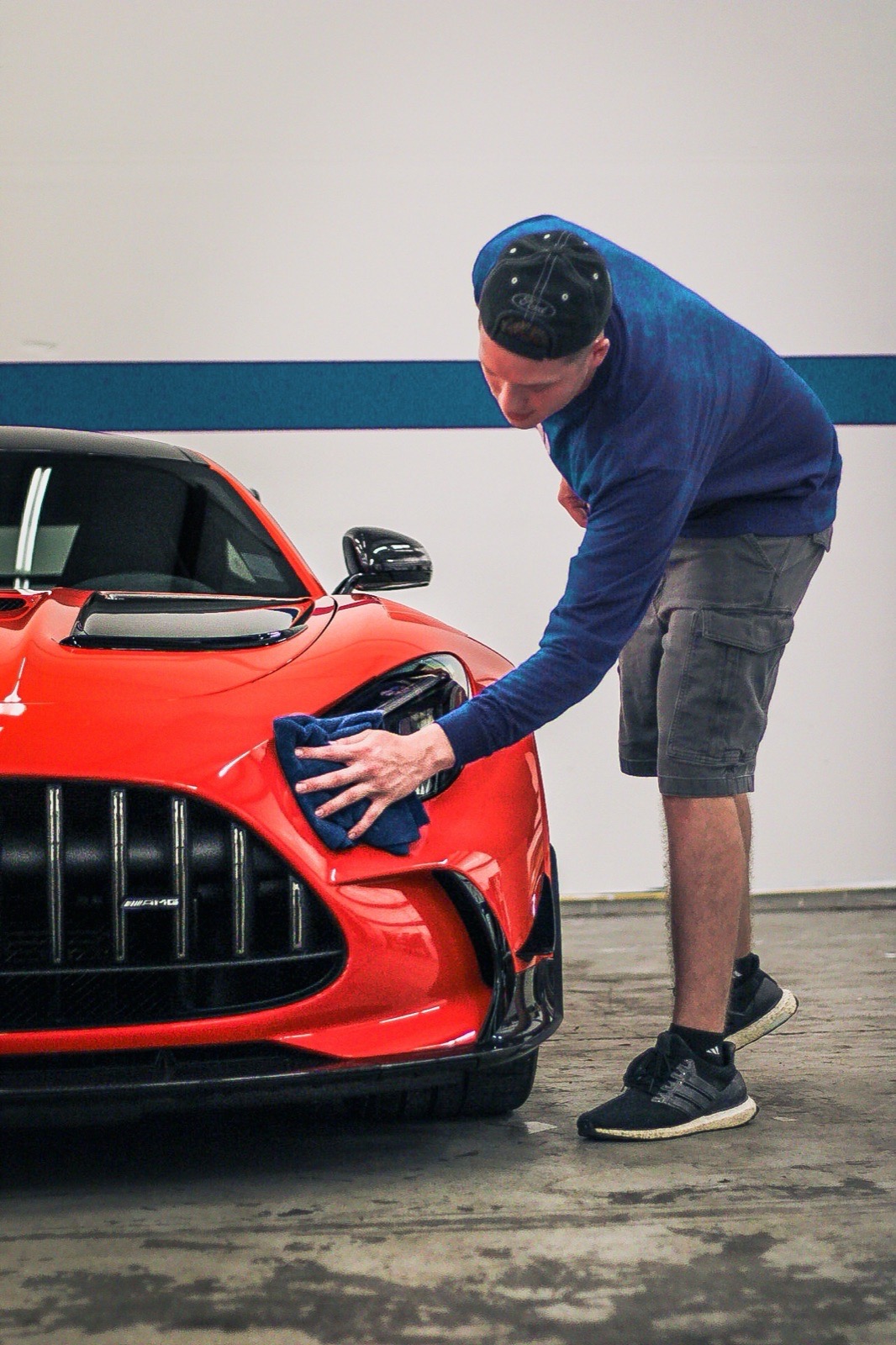 Detailer hand polishing an AMG at Obsidian Detail Studios in Baltimore