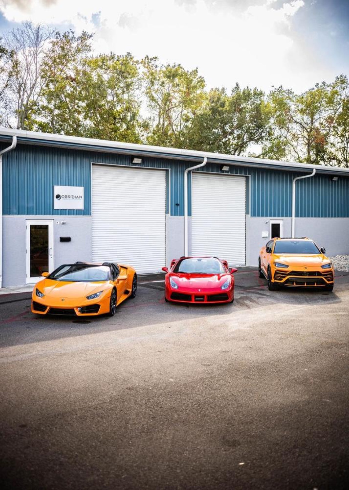 Lamborghini, Ferrari, and Urus outside Obsidian Detail Studios in Baltimore